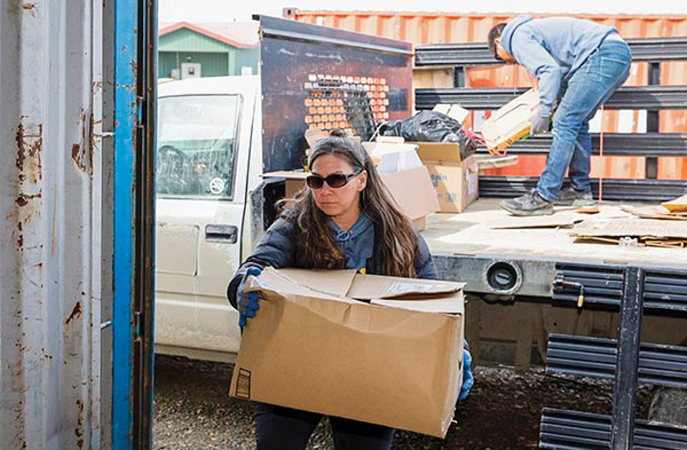 Anahma Shannon, environmental program director at Kawerak unloading boxes off of a truck