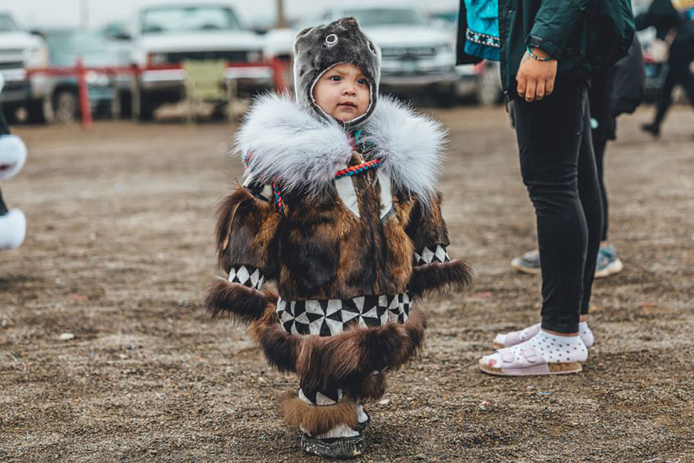 Toddler in brown traditional fur attire