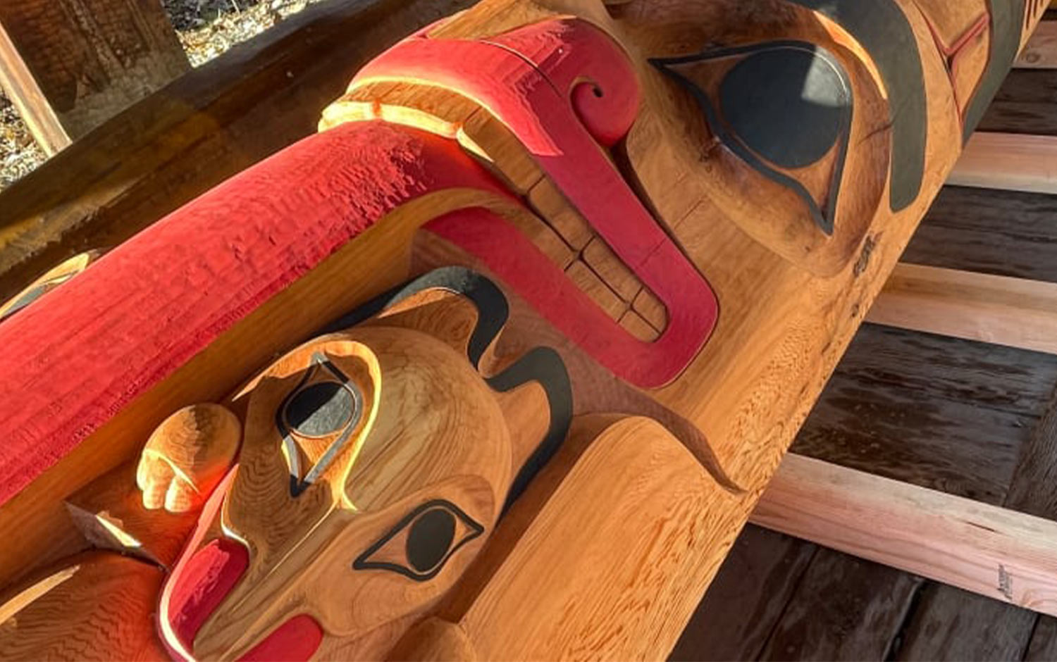 close angled view of the lower figure on the Boarding School Healing Totem Pole