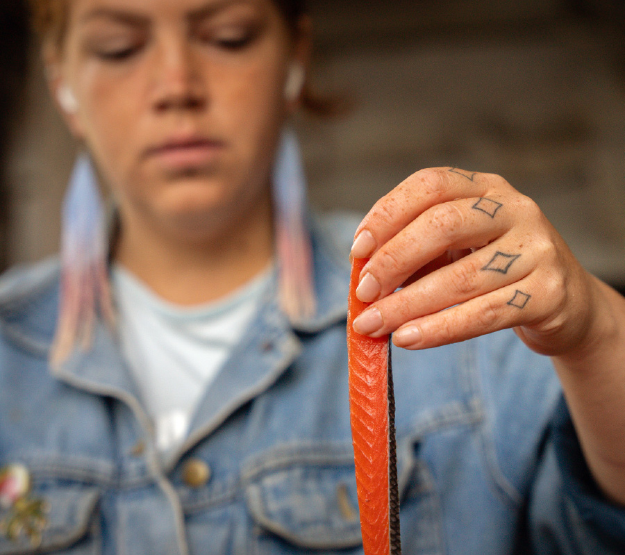 Marina Anderson with a strip of sockeye salmon in her hand