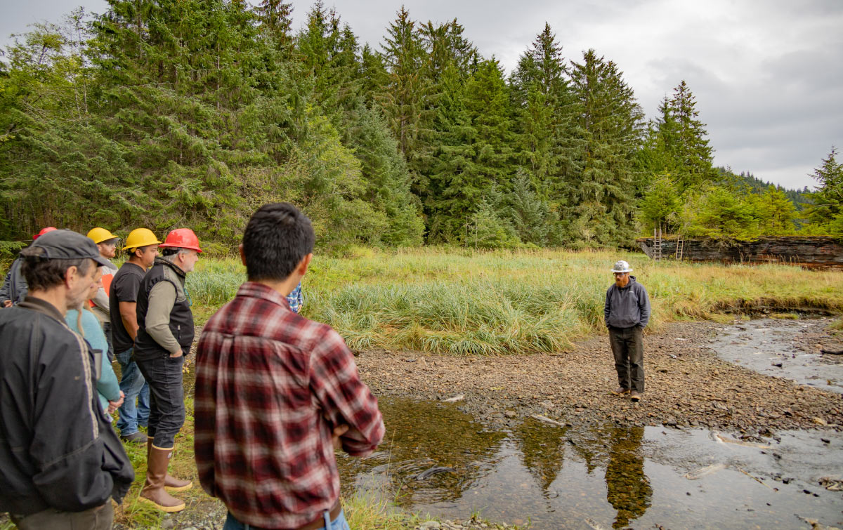 Quinn Aboudara with National Forest Service staff in forrest near small creek